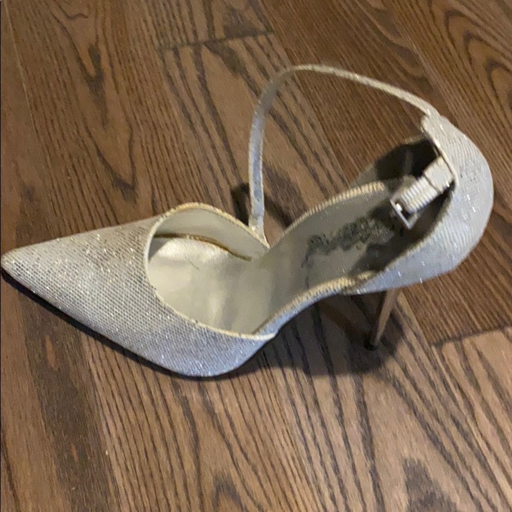 Silver high heel closed toe shoes.